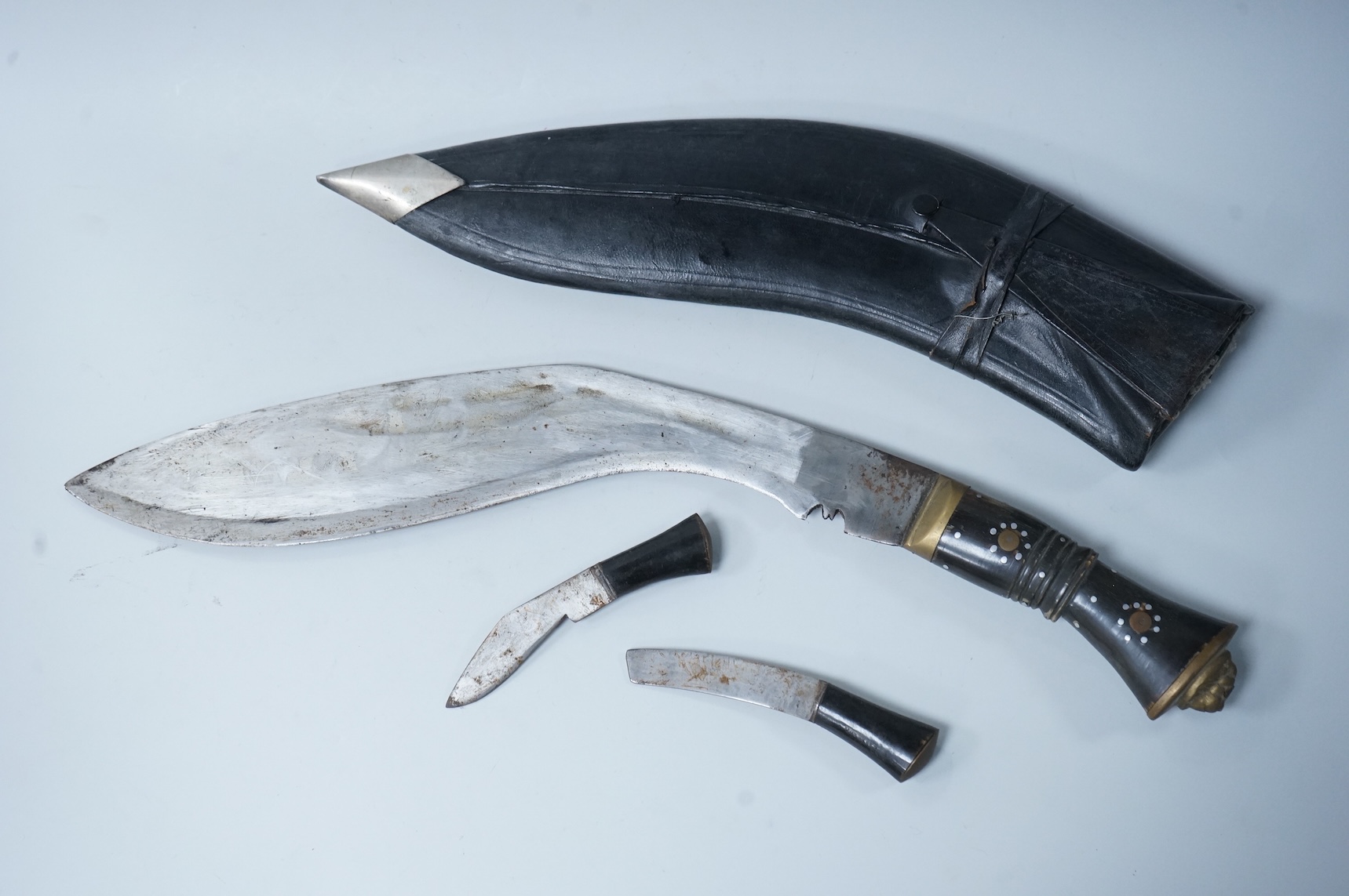 Two kukri knives in leather covered scabbards